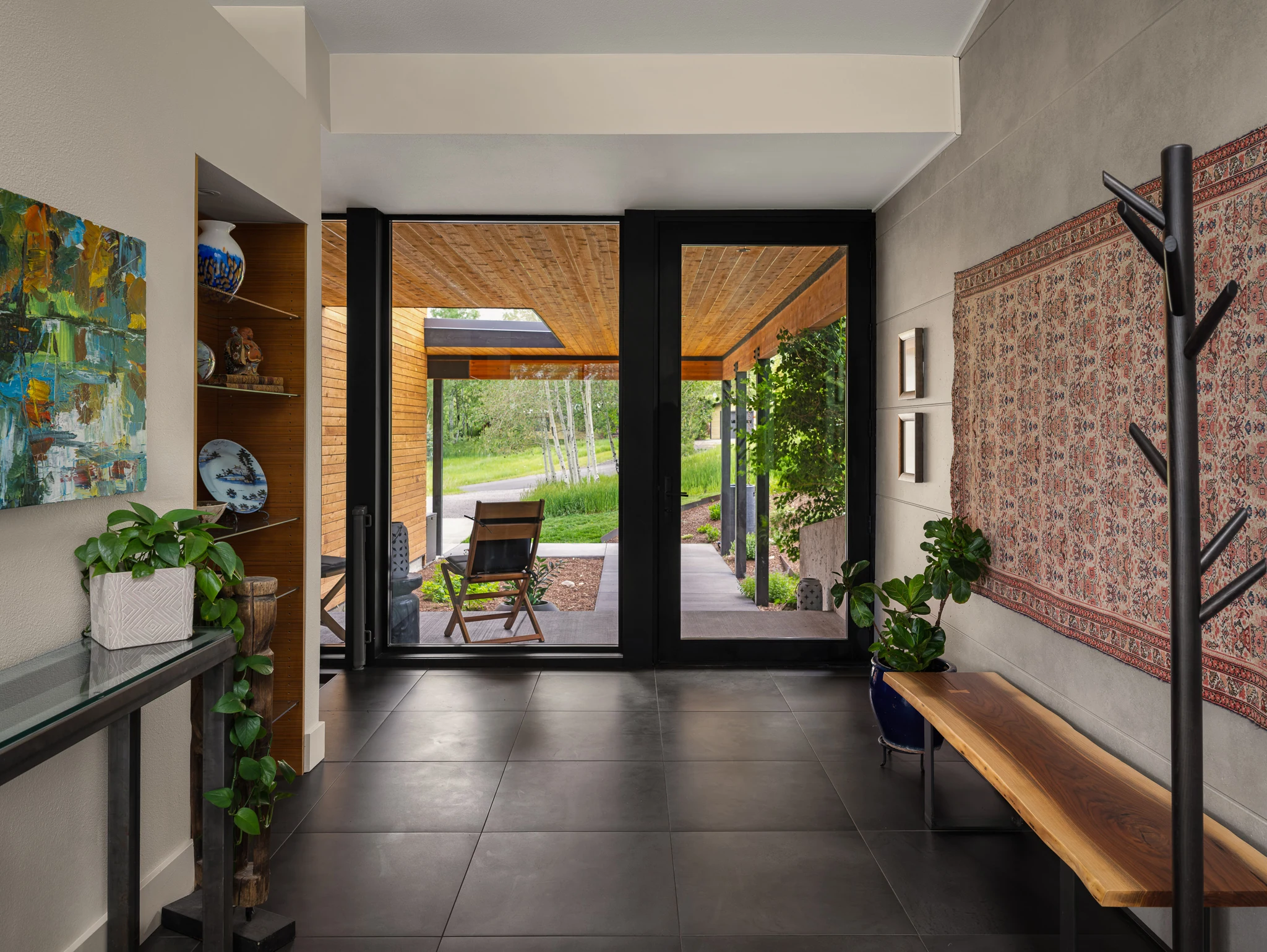 Entry hallway view through glass doors to the covered walkway — architectural photography Bozeman Montana, Bozeman Overlook